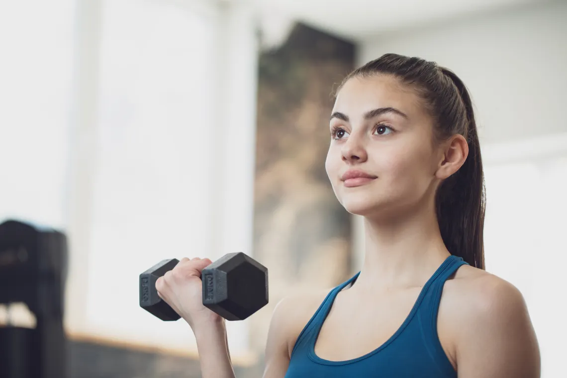 Youth fitness teen lifting dumbell weight 