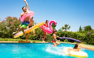 Kids jumping in a pool, summer bash pool party.